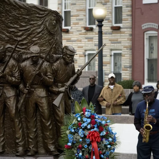 Musicians Joseph Witherspoon (fore left), on saxophone, and Alan Clipper Sr (fore right), on trumpet, perform 'We Shall Overcome' after a wreath laying at the African-American Civil War Memorial