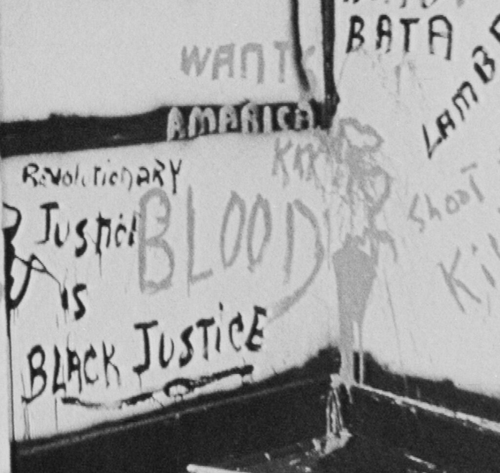Close up of graffiti that says "Revolutionary Justice is Black Justice"