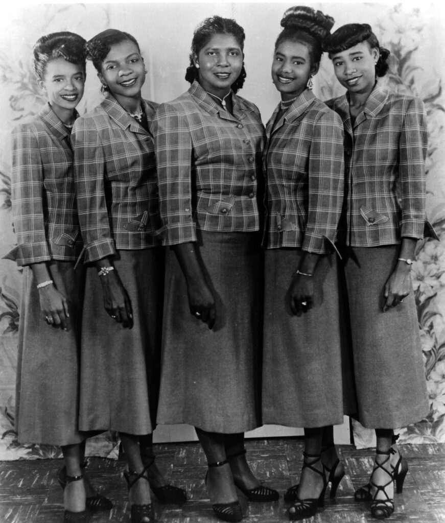 Gospel guitar player and singer Sister Rosetta Tharpe (center) poses for a portrait with her back up singers "The Rosettes" in circa 1950.