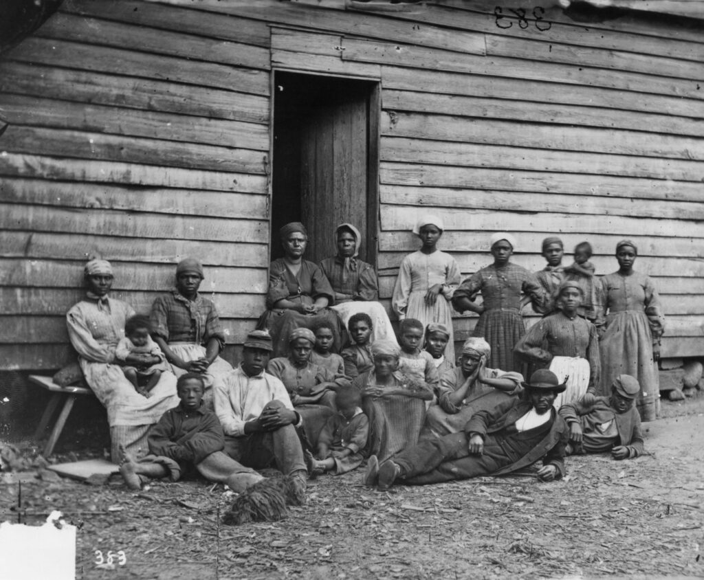 A group of escaped slaves outside a cabin in 1861. Escaped slaves were known as contrabands after the Union General Benjamin Butler (1818 - 1893) announced that any slaves in land controlled by the Union Army would be regarded as contraband property.
