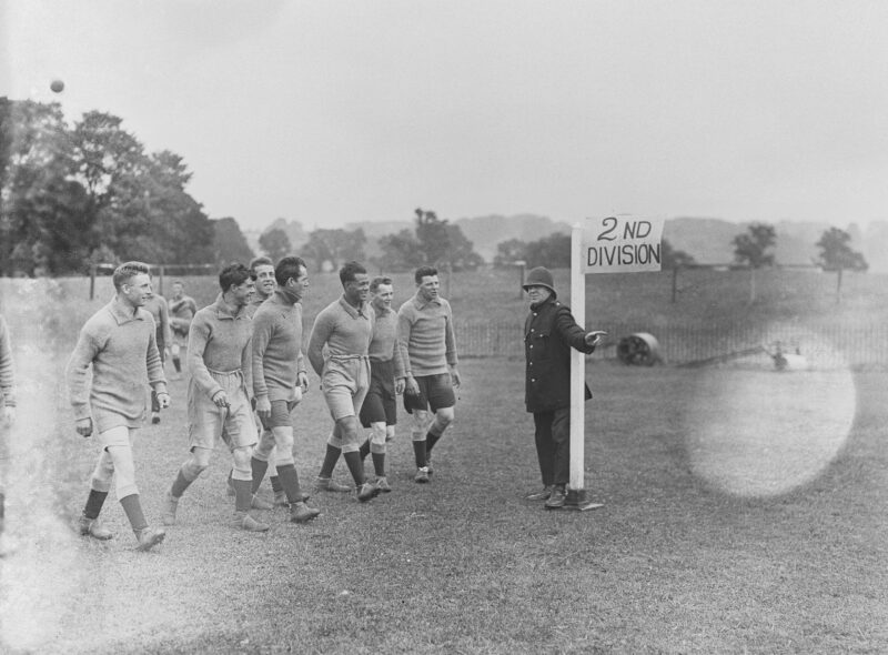 Plymouth Argyle FC trainer Tommey Haynes as a points duty policeman directing the way to promotion, UK, 10th August 1926. Third from right is Jack Leslie.