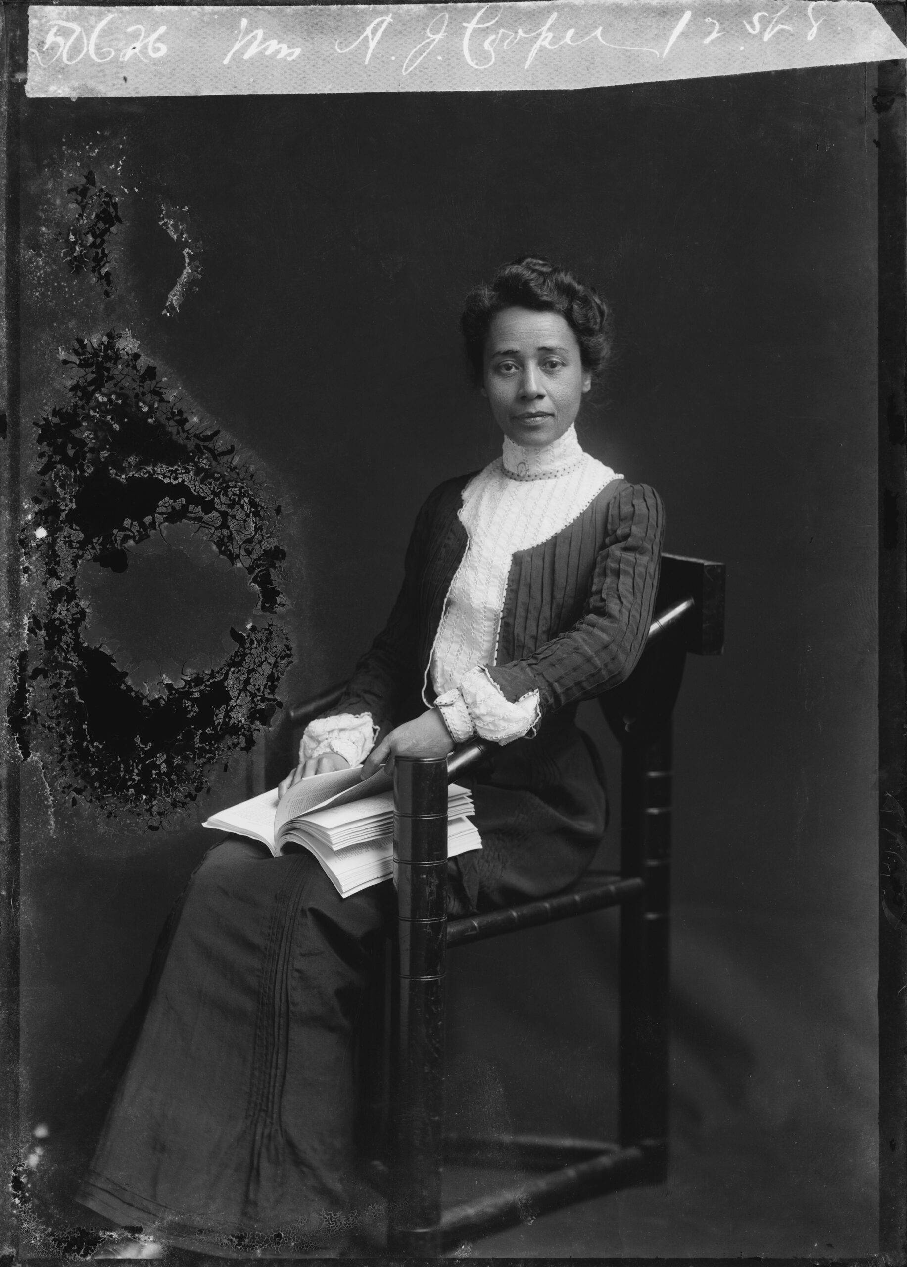 Educator and civil rights activist Anna Julia Cooper (1858-1964) poses for a photo while sitting with book on her lap circa 1902 in Washington DC.