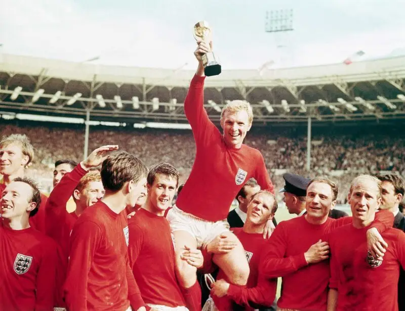 England captain Bobby Moore "chaired" by his team with the Jules Rimet Cup...after receiving it from the Queen after England won the Cup final 4 goals to 2, against West Germany.