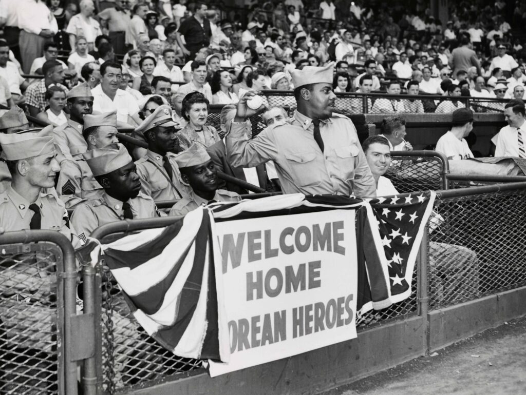A repatriated former prisoner of war named as Private First Class Rafael Mora-Rosa has the honour of throwing the first ball to open a game between the Brooklyn Dodgers and the Cincinnati Reds in New York on August 29th, 1953.