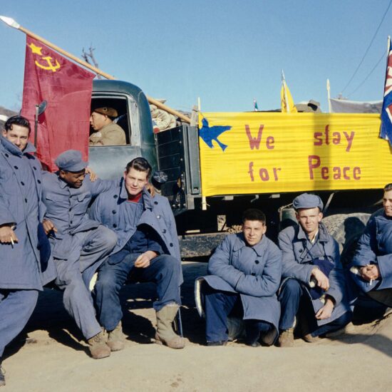 Five of the 21 American soldiers who refused to return to America at the end of the Korean War. The sign on the truck reads: "We Stay for Peace." They moved to China; by the 1960s, all but two had returned home.