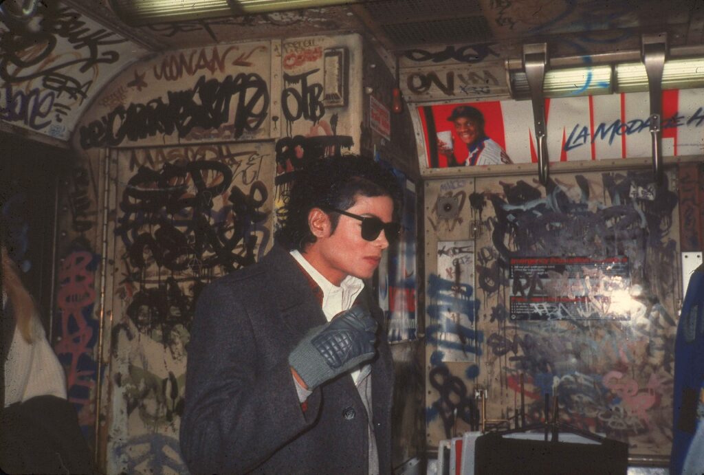 Popular American musician Michael Jackson (1958 - 2009) stands in a graffiti-filled subway car during the filming of the long-form music video for his song 'Bad,' directed by Martin Scorsese, New York, New York, November 1986.