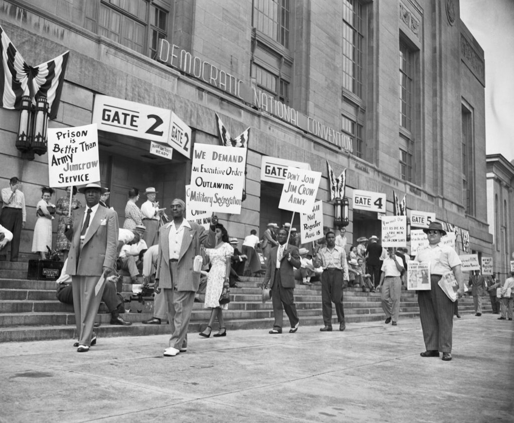  7/12/1948-Philadelphia, PA: Picketers outside Democratic National Covention, July 12, demanding equal rights for Negoes and Anti-Jim Crow plank in the Party platform. Leading the pickets is A. Philip Randolph (Left), President of the Board of Sleeping Car Porters and Chairman of the League for Non-Violent Civil Disobedience against Military Segregation.