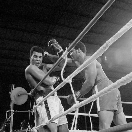 Heavyweight champion George Foreman (r) and Muhammad Ali (l) exchange punches during their world heavyweight title boxing match in 1974.