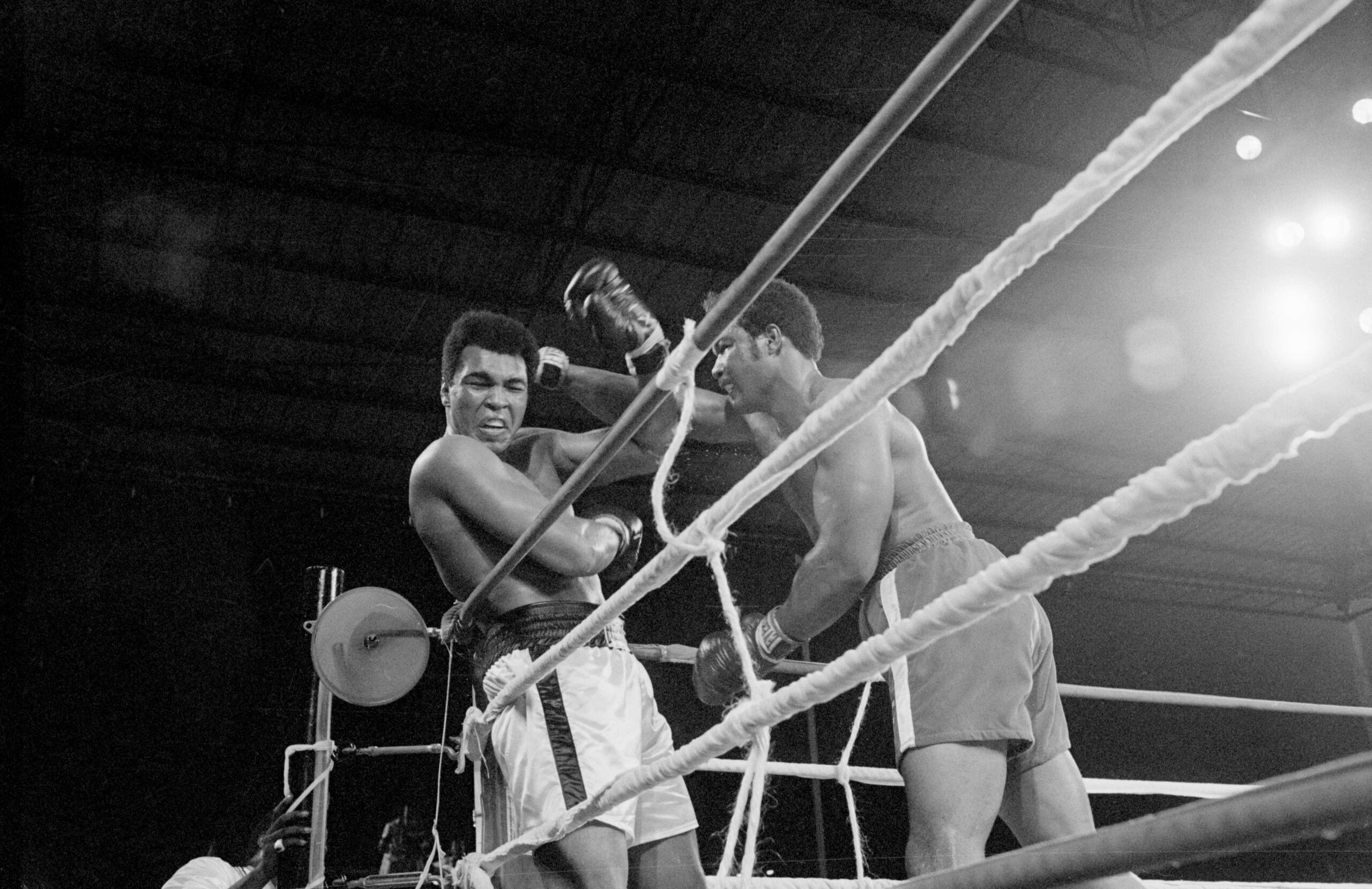 Heavyweight champion George Foreman (r) and Muhammad Ali (l) exchange punches during their world heavyweight title boxing match in 1974.