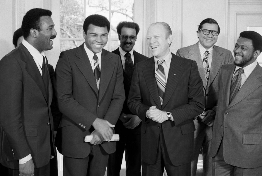 12/10/1974-Washington, D.C.- World heavyweight champion Muhammad Ali and his brother Herbert Clay (L) meet with President Ford at the White House. Ali said he liked the White House, and just might go after the job. Ford said there were times he'd be happy to let him have it.