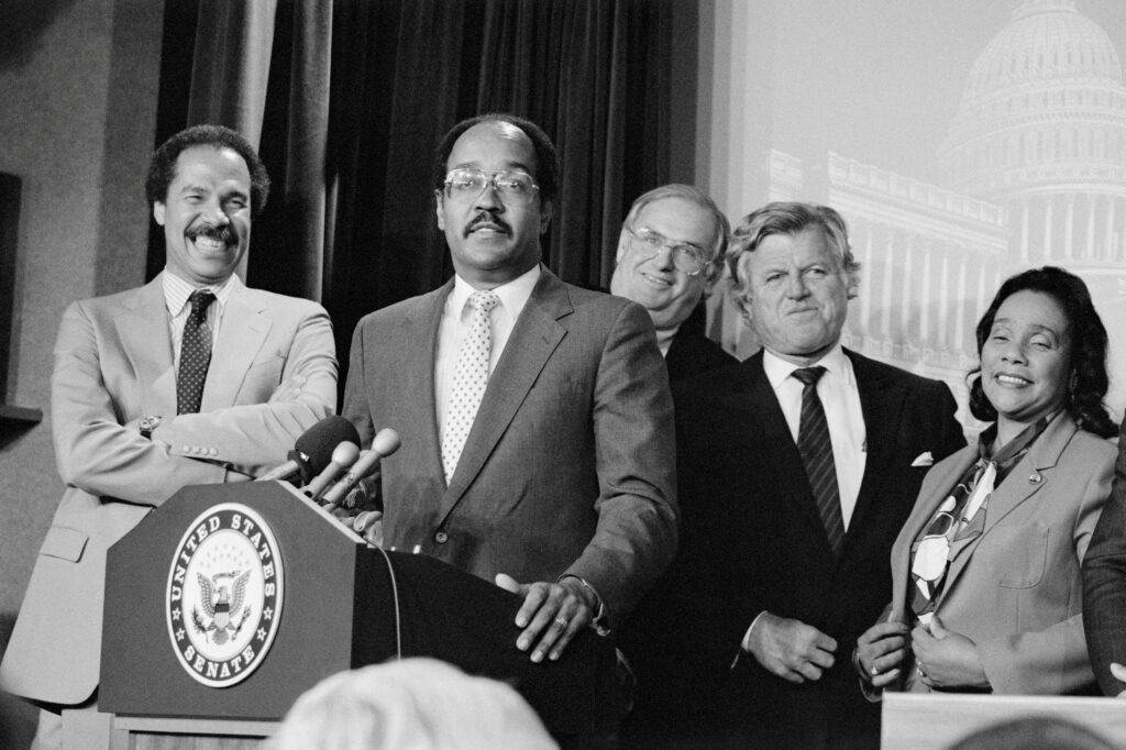 Officials address questions during a press conference following the Senate vote to override President Reagan's veto of sanctions against South Africa.